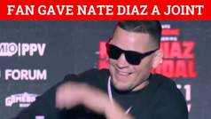 Nate Diaz smokes a joint thrown at him by a fan in middle of press conference