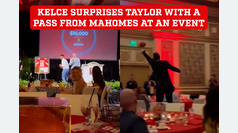 Travis Kelce's impressive catch surprises Taylor as Mahomes throws a pass from the stage at an event