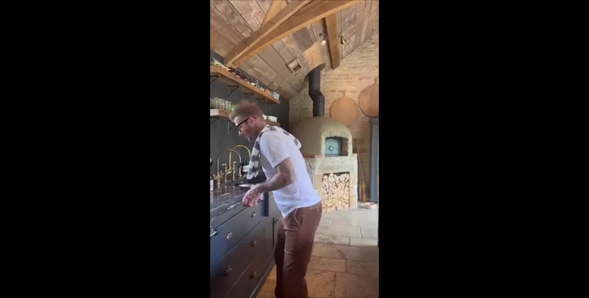David Beckham shows off his skills in the kitchen to the tune of Juan Gabriel