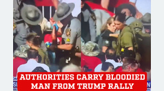 Authorities carry a bloodied man away from Donald Trump's Pennsylvania rally